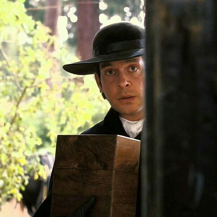 A still from the 2005 film adaptation of Pride and Prejudice depicting the moment when the door at Longbourne is opened to reveal Mr. Collins, as played by Tom Hollander.