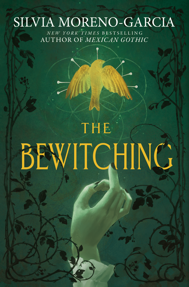 The cover of The Bewitching, featuring black filigree in the fore of a dark green background. A pale hand tinted green reaches up for a gold bird surrounded by sewing pins. The cover is between hand and bird, also in gold.